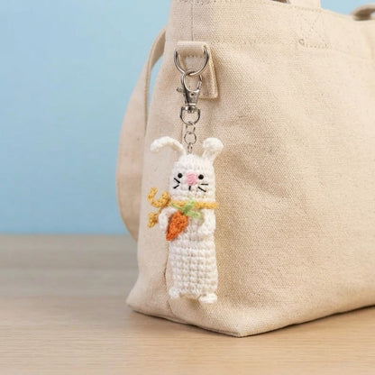 Handmade WoolyArtis crochet sensory fidget keychain with bunny, carrot, and pickle designs, featuring satisfying click-clack sounds.